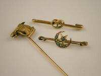 A stick pin and two brooches