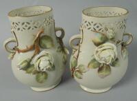 A pair of Victorian flower encrusted pottery vases