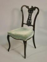 An Edwardian ebonised and carved salon type chair