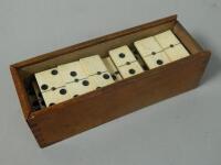 A part set of 19thC bone dominoes in fitted case