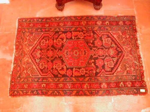 A Middle Eastern rug, with central lozenge medallion on a blue grou nd,