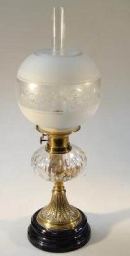 An Edwardian brass and glass oil lamp