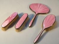 A harlequin silver plate and pink enamel four piece dressing table set