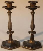 A pair of early 20thC pewter candle sticks