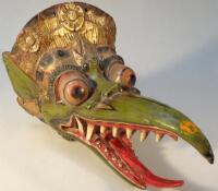 A heavily carved Chinese wall mask in the form of a dragon's head