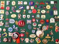 A quantity of various enamel pin badges