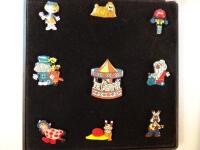 A set of nine enamel Magic Roundabout badges