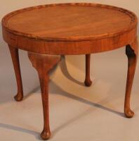 A 1920s walnut coffee table