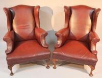 A pair of early 20thC wing armchairs