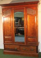 A Victorian walnut triple wardrobe