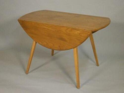 An Ercol pale elm oval drop leaf table