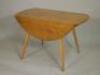 An Ercol pale elm oval drop leaf table