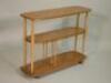 An Ercol pale elm rectangular three tier trolley