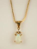 An opal and diamond pendant and chain