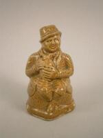 A stoneware figural money box