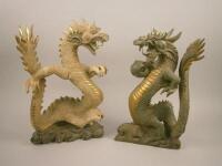 A pair of carved wood and parcel gilt oriental dragons