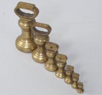 A set of seven vintage graduated brass weights