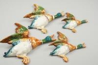 A set of four graduated Beswick flying ducks