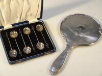 A pair of silver shell spoons and a silver hand mirror