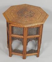 A Middle Eastern style octagonal hardwood and brass and copper inlaid table