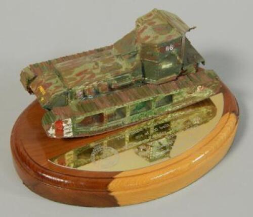 A painted metal model of a tank