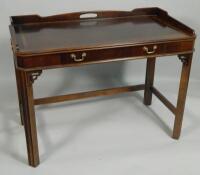 A reproduction mahogany writing table