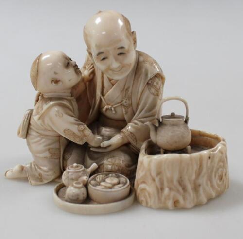 A Japanese carved ivory okimono figure group