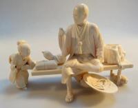 A Japanese carved ivory figure group