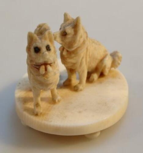 A Japanese ivory carving of two dogs