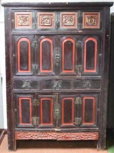 A large Chinese stained and painted pine marriage cabinet