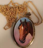 An oval porcelain pendant painted by James Edwin Dean