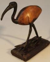 An early 20thC hardwood and metal figure of an ibis