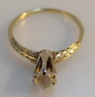 A diamond solitaire ring