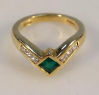 An 18ct gold emerald and diamond ring