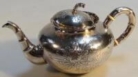 A Chinese white metal teapot