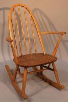 An Ercol lightwood rocking chair