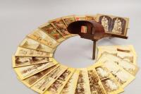 A stereoscopic viewer and a collection of vintage cards