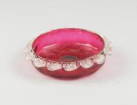 A Victorian cranberry glass shallow bowl with crimped border