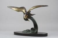 After Irenee Rochard. A bronze figure of a bird and cresting wave upon black marble plinth