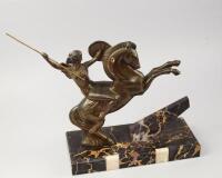 An Art Deco bronze patinated figure group of a female warrior on horseback