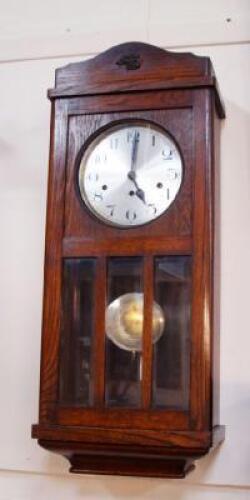 A 1930s oak wall clock