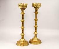 A pair of brass Gothic Revival ecclesiastical pricket candlesticks