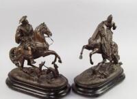 A pair of Victorian bronze patinated spelter figures of mounted Tudor figures with hunting dogs