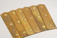 A set of nine brass door finger plates.