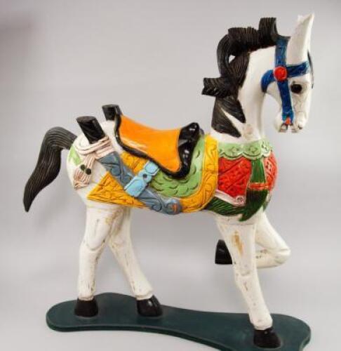 A carved and painted ornamental wooden horse