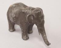 An Oriental white metal model of an elephant