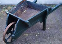 A wooden trug style wheelbarrow.