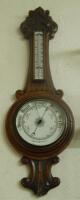 A late Victorian carved walnut aneroid barometer