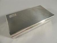 An engine turned rectangular silver cigarette box