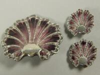 A white metal and purple enamel shell shaped brooch and matching earrings